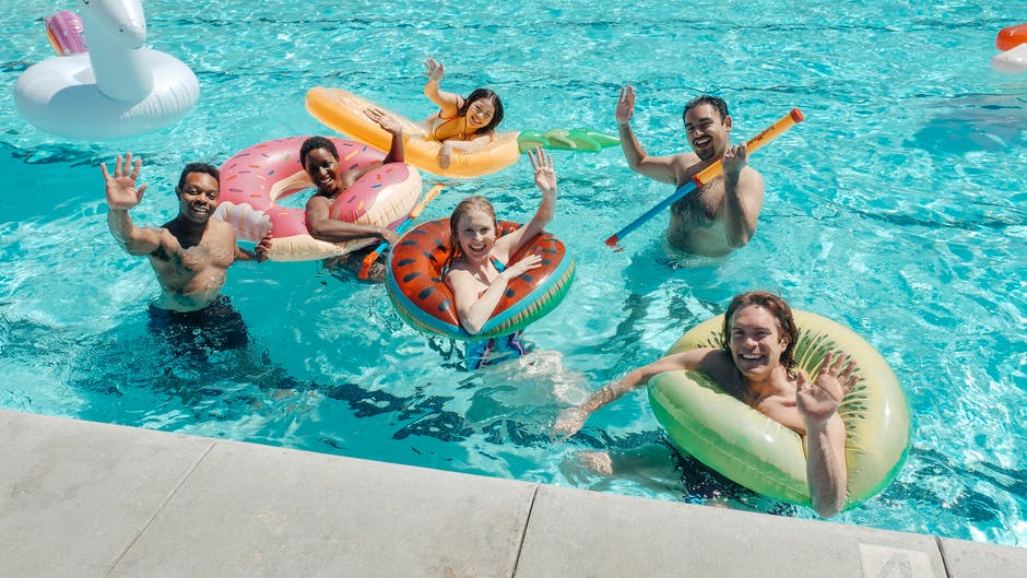 Swimmers swimming with swim rings 