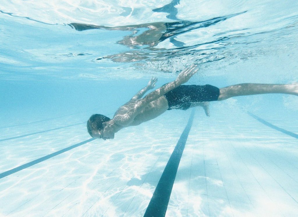male swimmer swimming under water