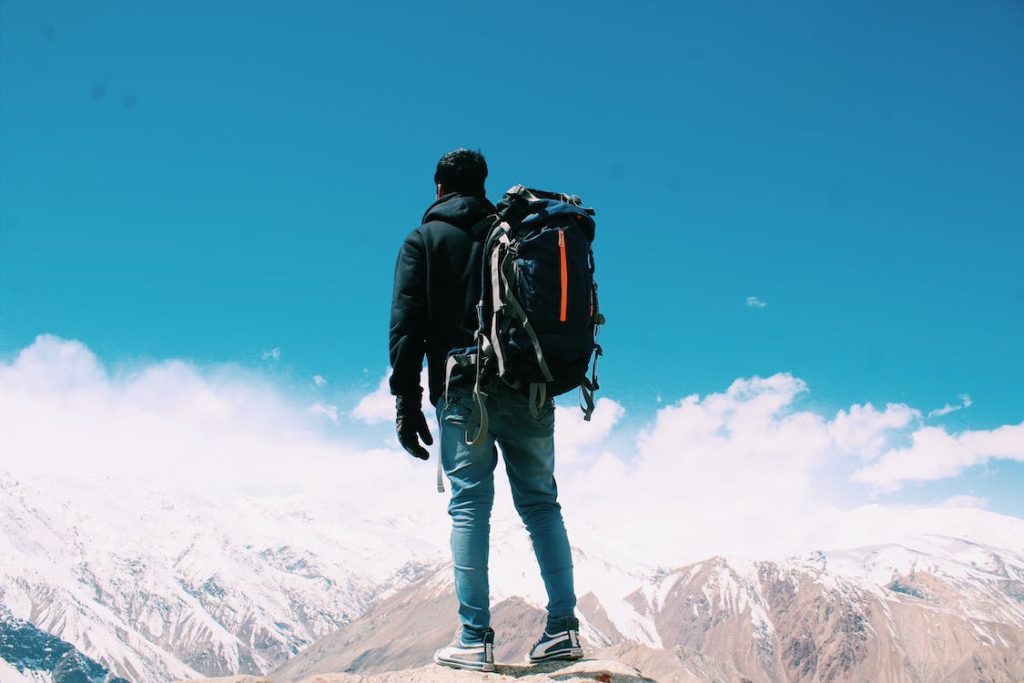 man standing with a swim backpack