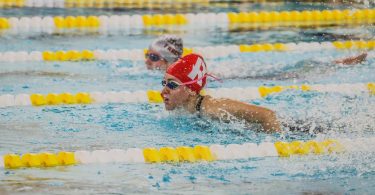 person in black swimming goggles in water