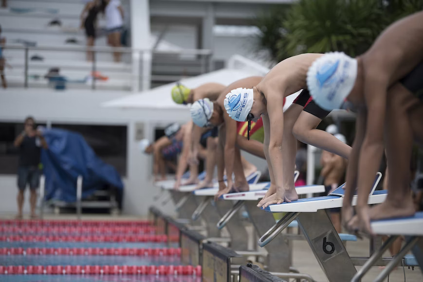 group swimmers setting up on the pool deck
