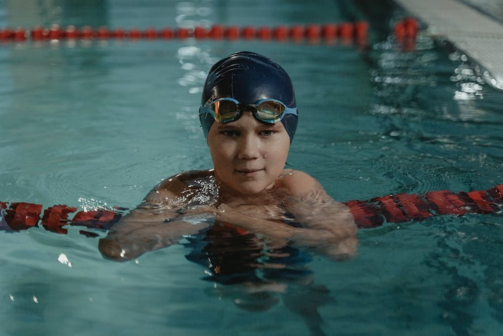 teenager swimming in a pool