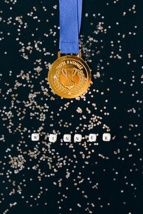 a gold medal in a black background