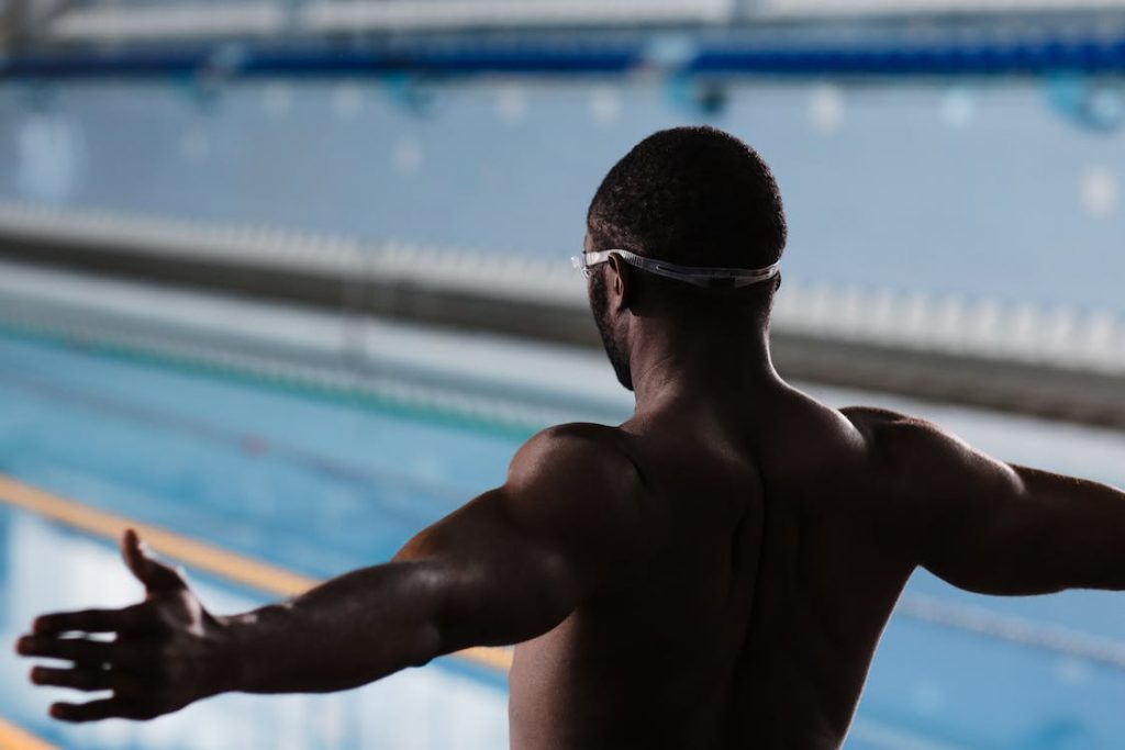 back view of a swimmer exercising his core muscles