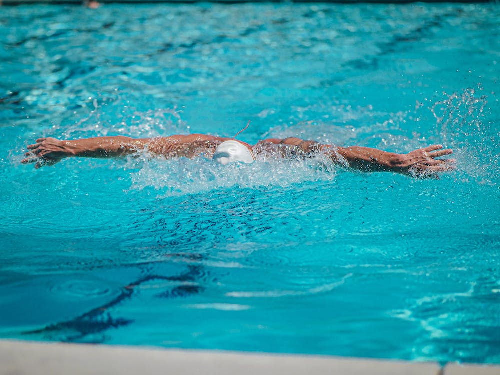male swimmer showing off his butterfly stroke technique
