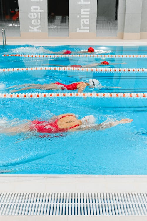 female swimmers maintaining a streamlined body in the swimming pool 