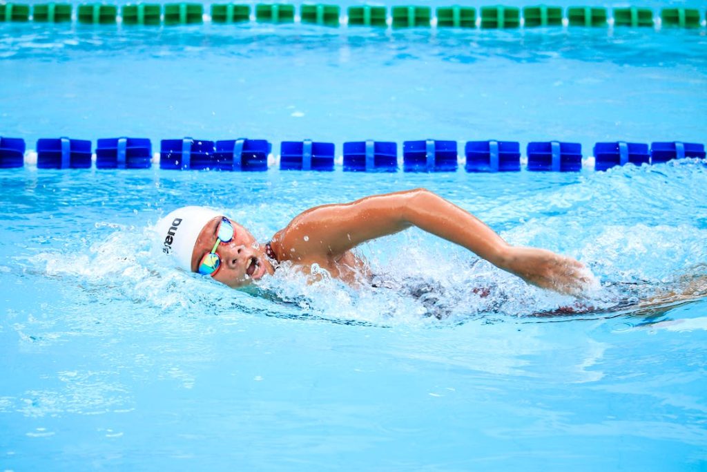 male freestyle swimmer practicing in the swimming pool