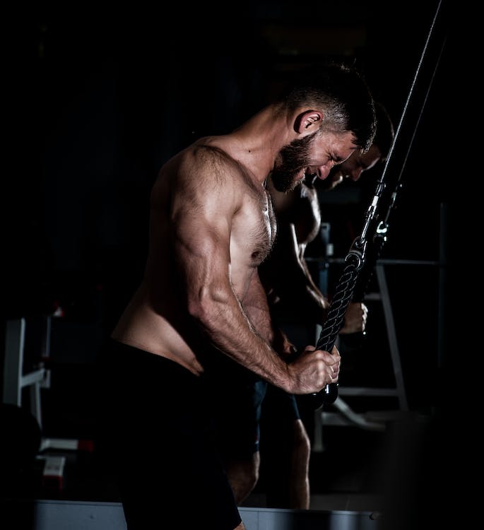 male fitness trainer training with a resistance band 