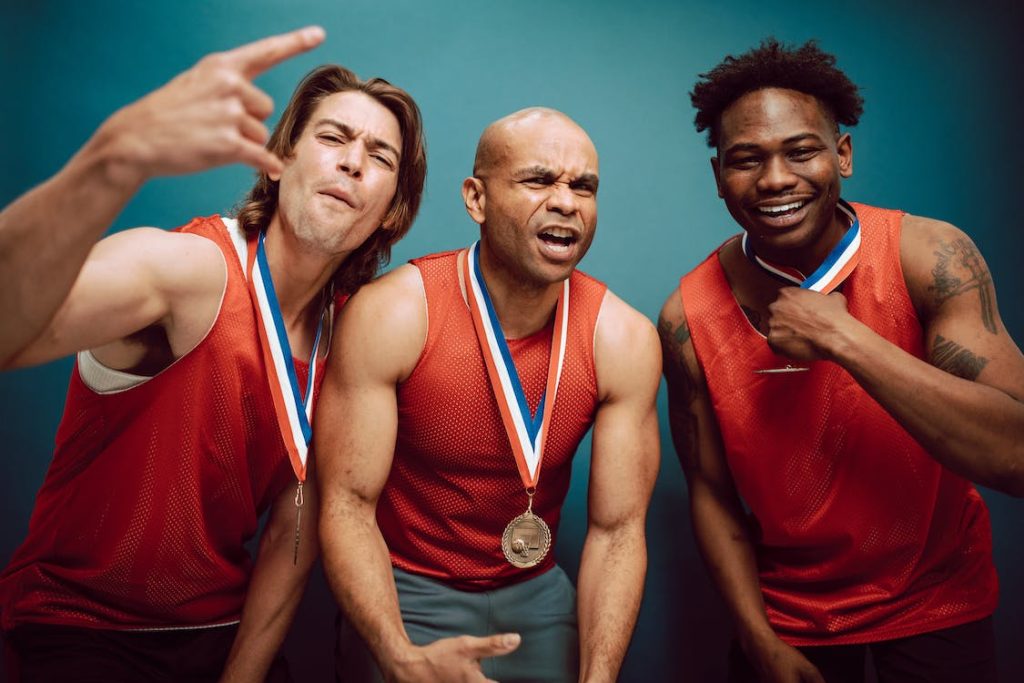 male swimmers sharing joyful moments together after a tie for gold