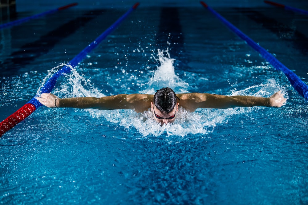 male swimmer swimming 100 yards in the swimming pool