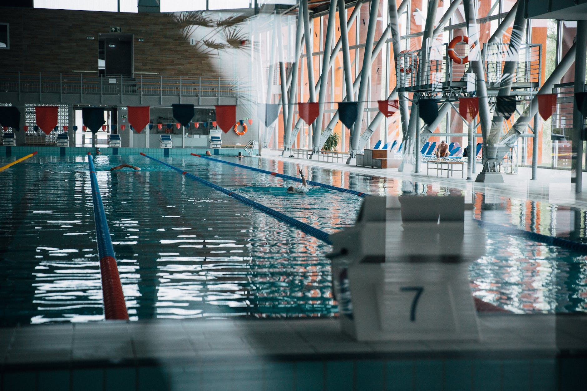 jumping block against rippled pool in modern building