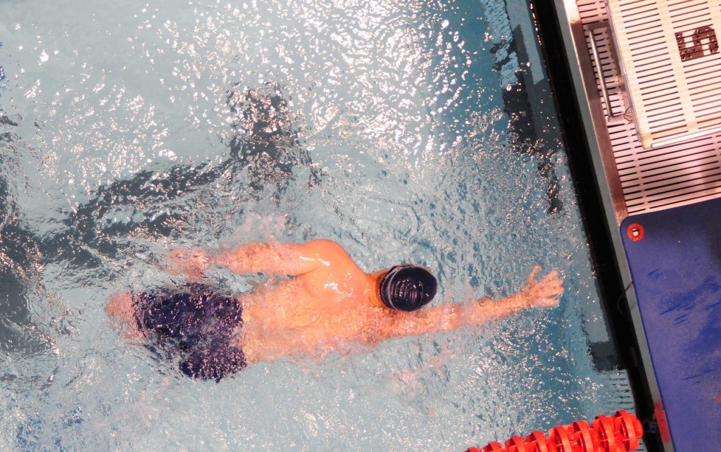 male swimmer maintaining a streamlined position in the water