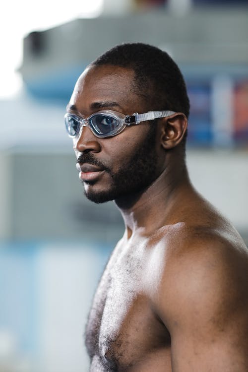 a male hairy swimmer with swim goggles on