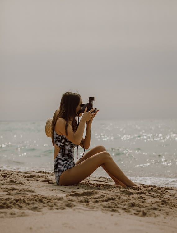 a lady capturing different angles of the beach