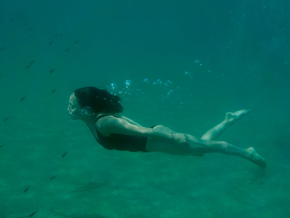 female swimmer practicing breathing under the water